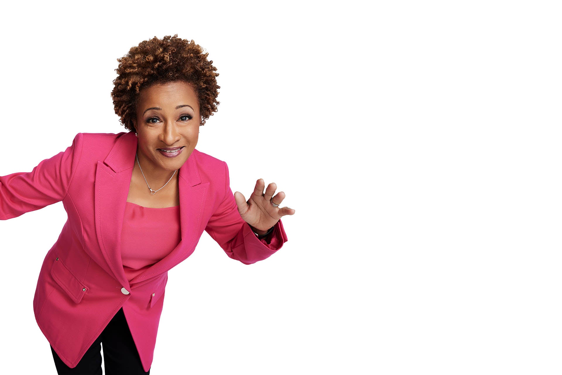 Photo of Wanda in a pink suit jacket and black pants in an active pose